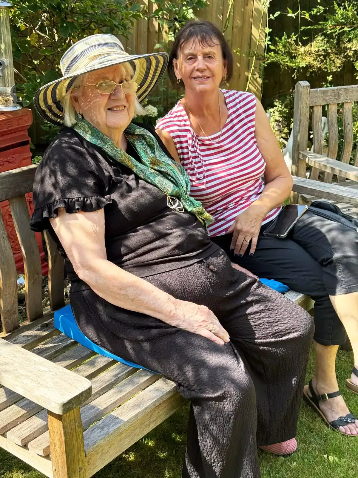 A family member enjoys a visit with their loved one in the garden.